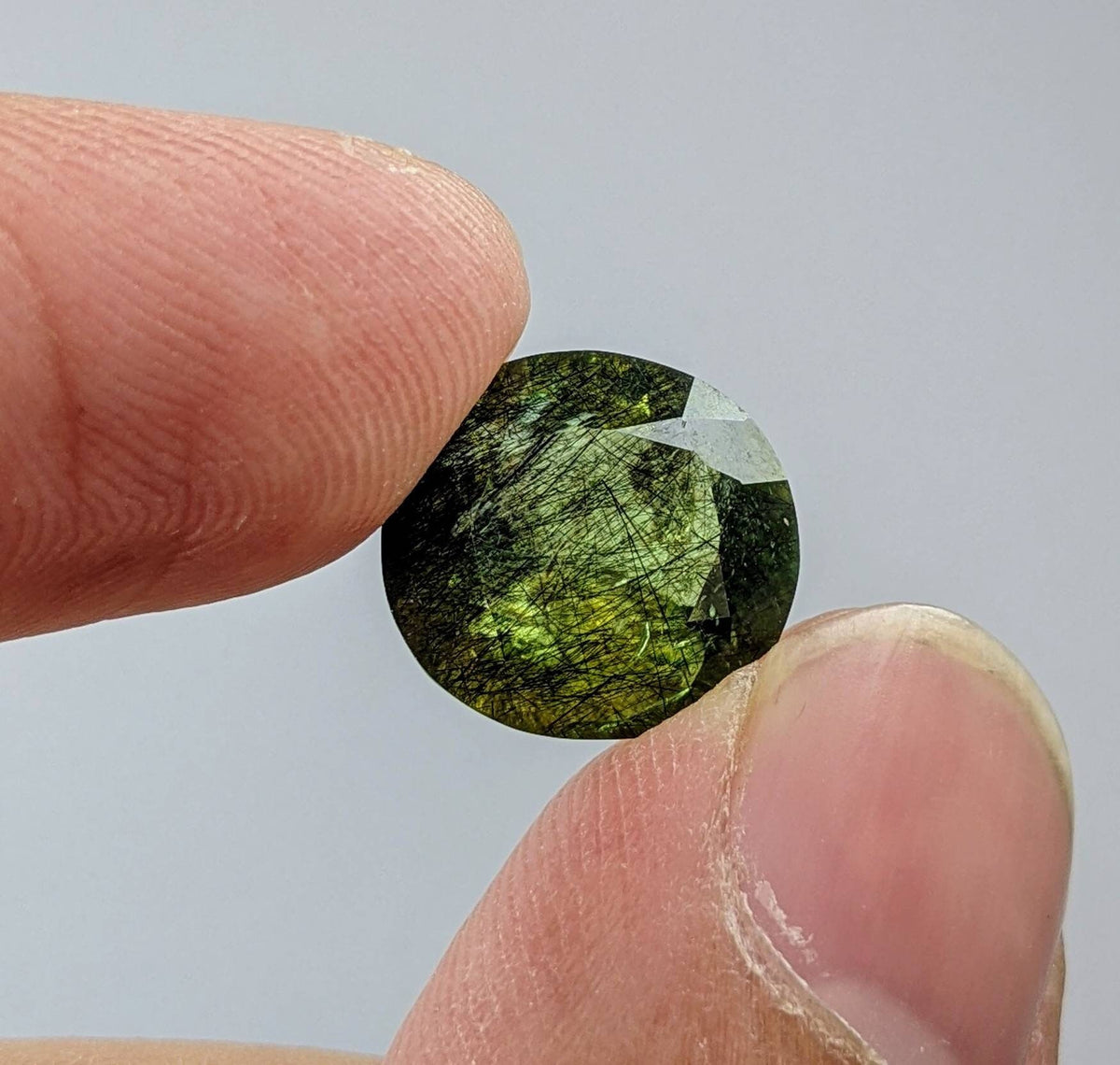 Rutile peridot Gem Peridot containing hairlike inclusions Ludwigite from Mansehra KP Pakistan, 7.5 carats