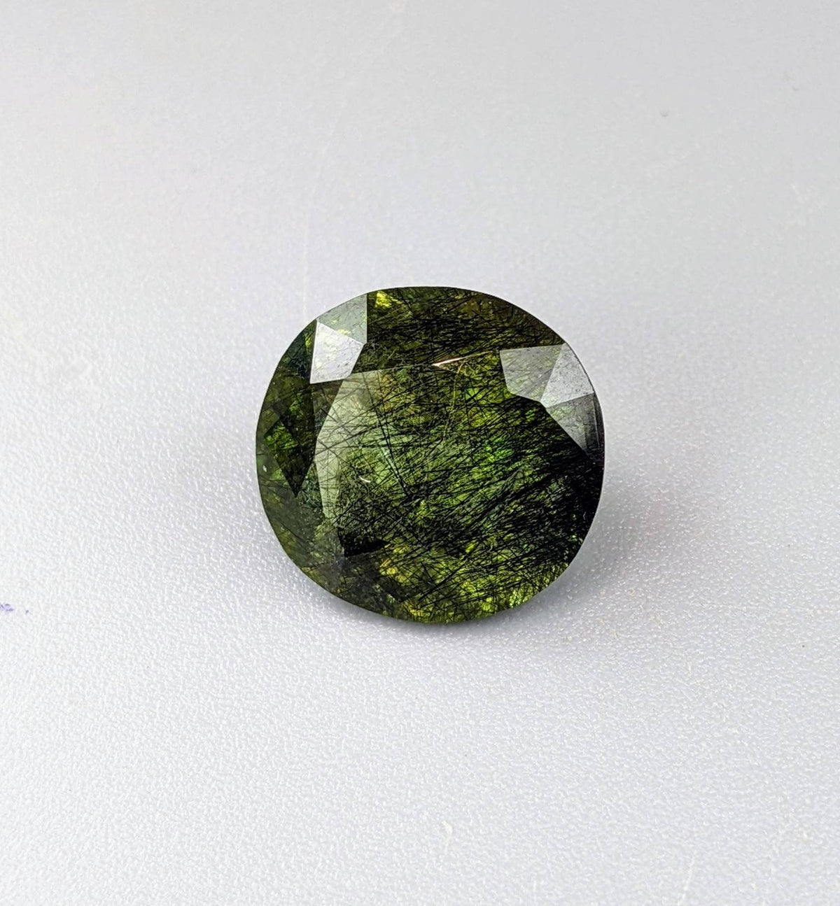 Rutile peridot Gem Peridot containing hairlike inclusions Ludwigite from Mansehra KP Pakistan, 7.5 carats
