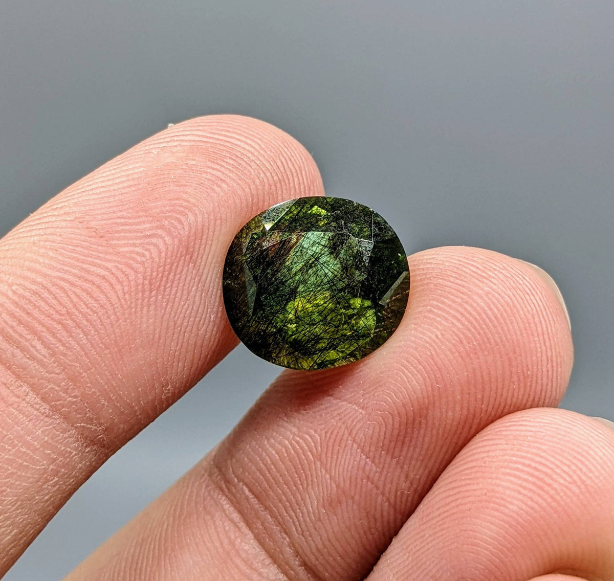 Rutile peridot Gem Peridot containing hairlike inclusions Ludwigite from Mansehra KP Pakistan, 7.5 carats