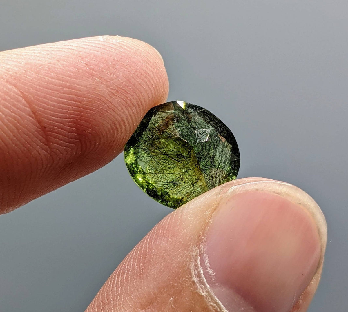 Rutile peridot Gem Peridot containing hairlike inclusions Ludwigite from Mansehra KP Pakistan, 7.5 carats