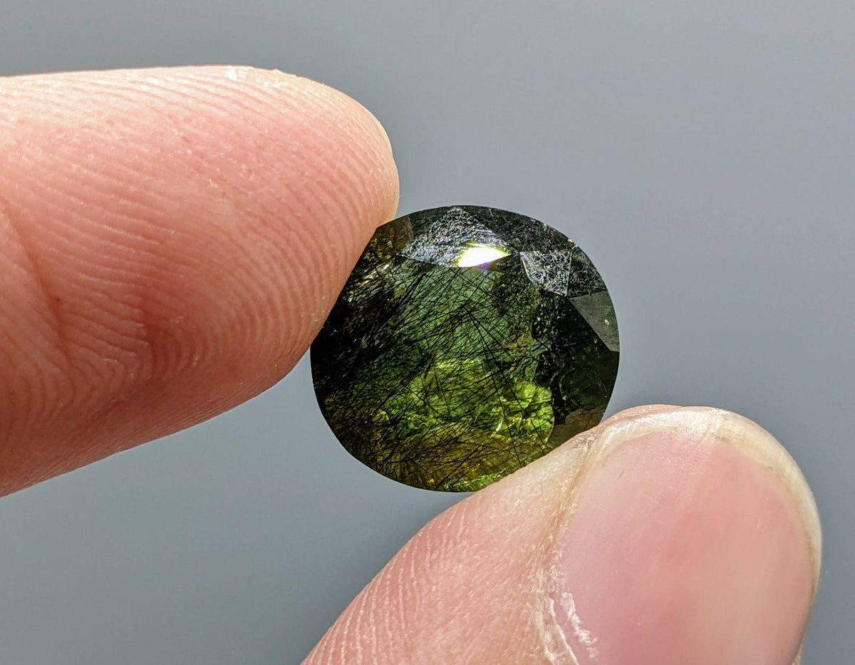 Rutile peridot Gem Peridot containing hairlike inclusions Ludwigite from Mansehra KP Pakistan, 7.5 carats